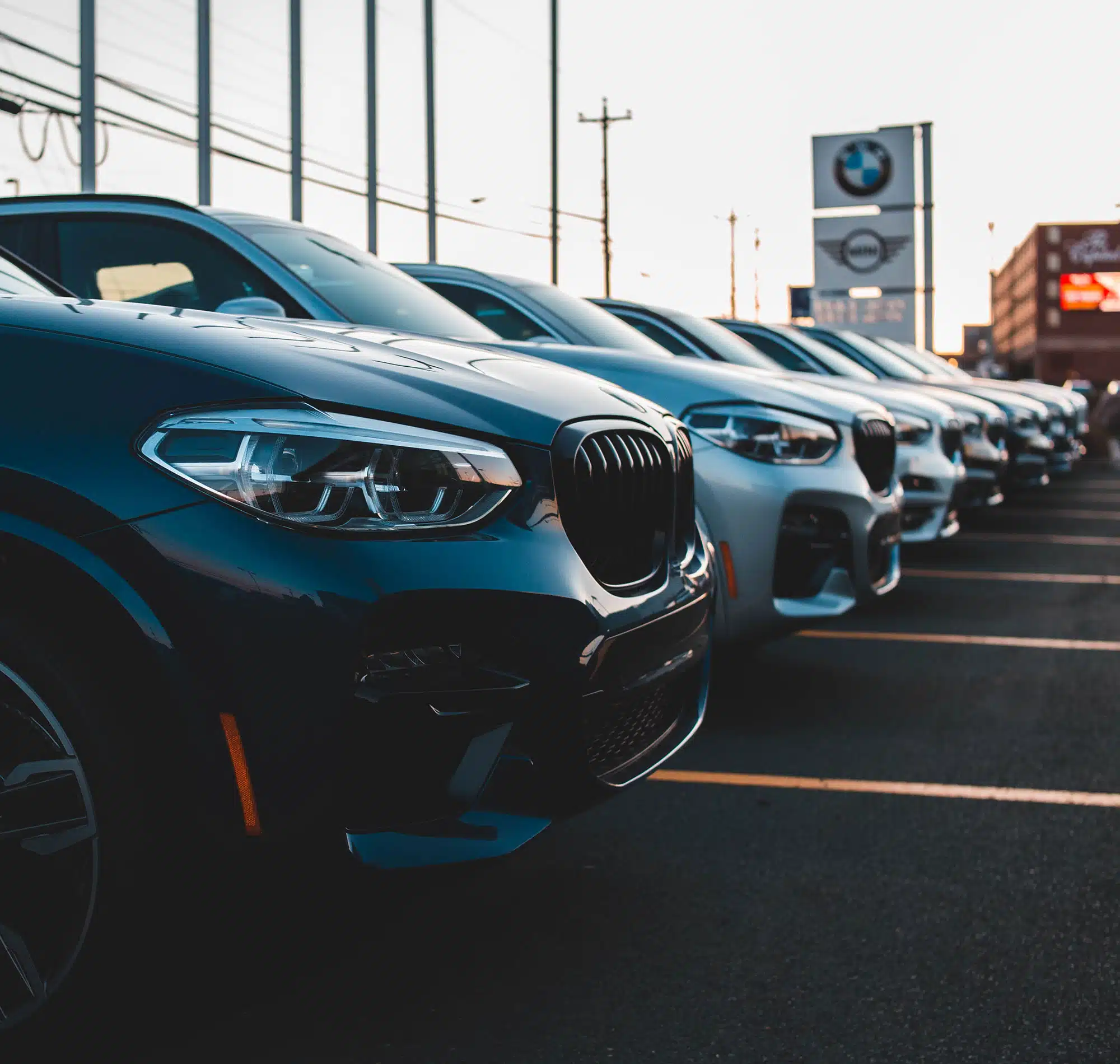 A row of BMW cars at a dealership